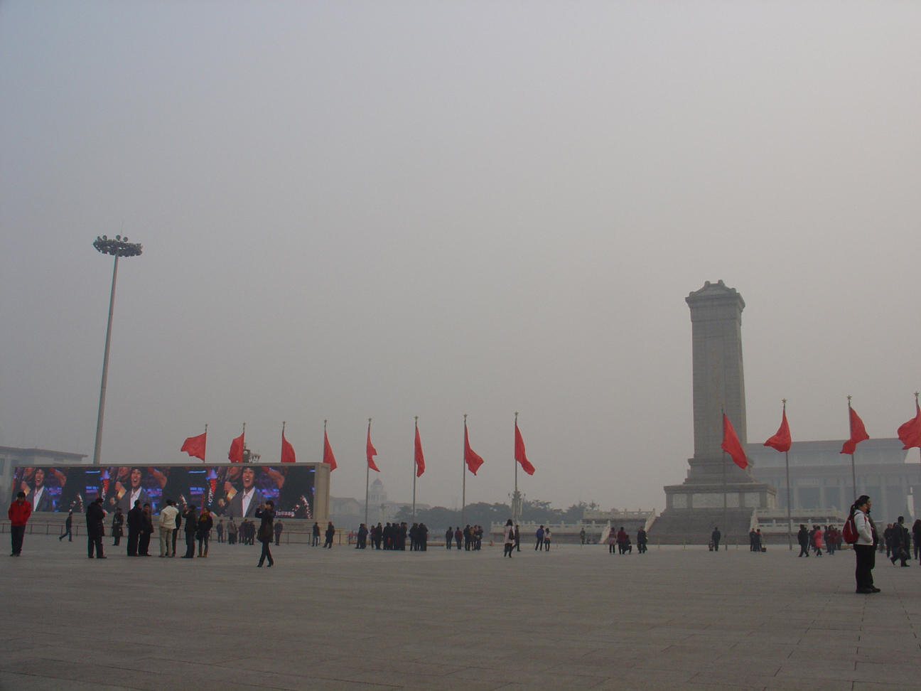 Tiananmen Square with blank red flags, the monument at the right hand and fucking huge LED Screens on the left hand.