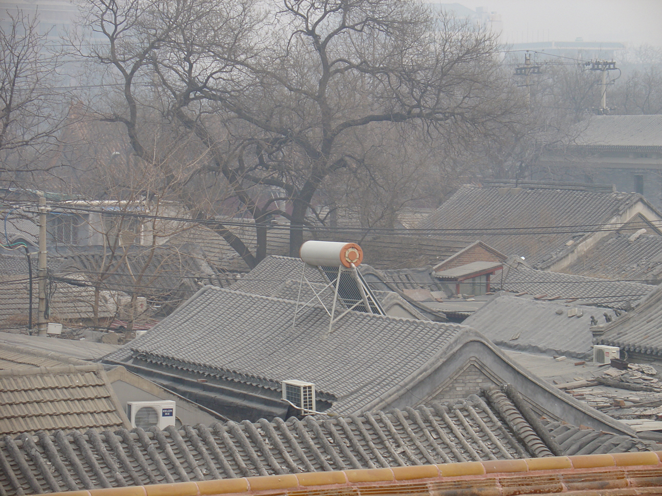 A solar panel on the roof of a very old chinese building- Green Power Now!