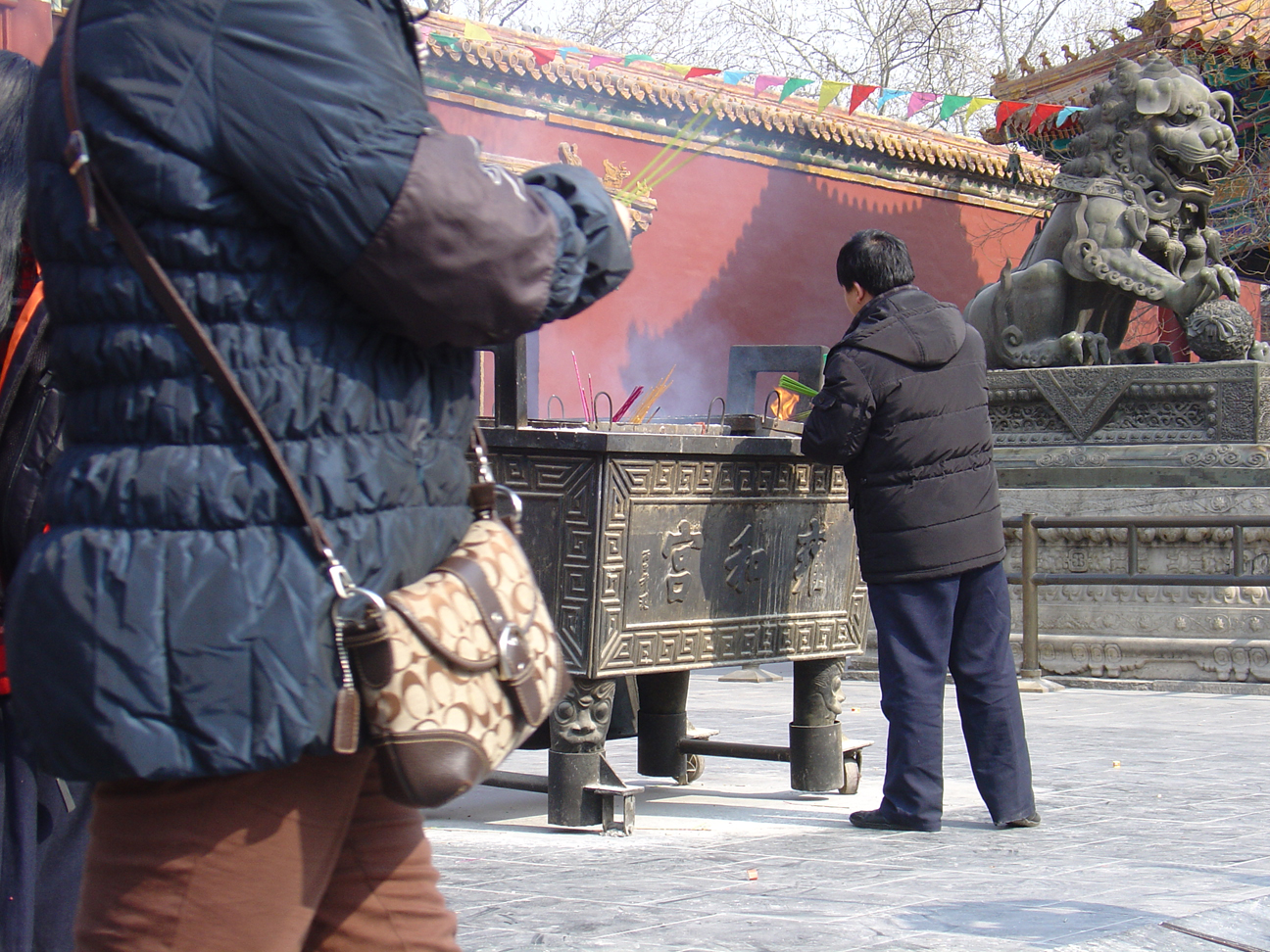 A Chinese man enkindling an incense stick