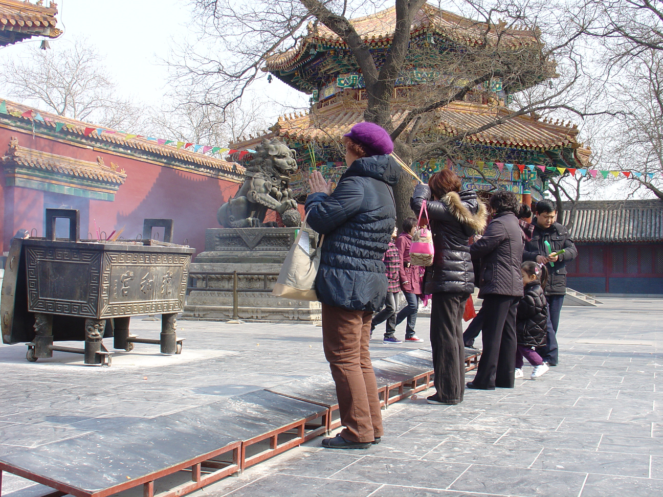 People are praying with incenses to worship Buddha