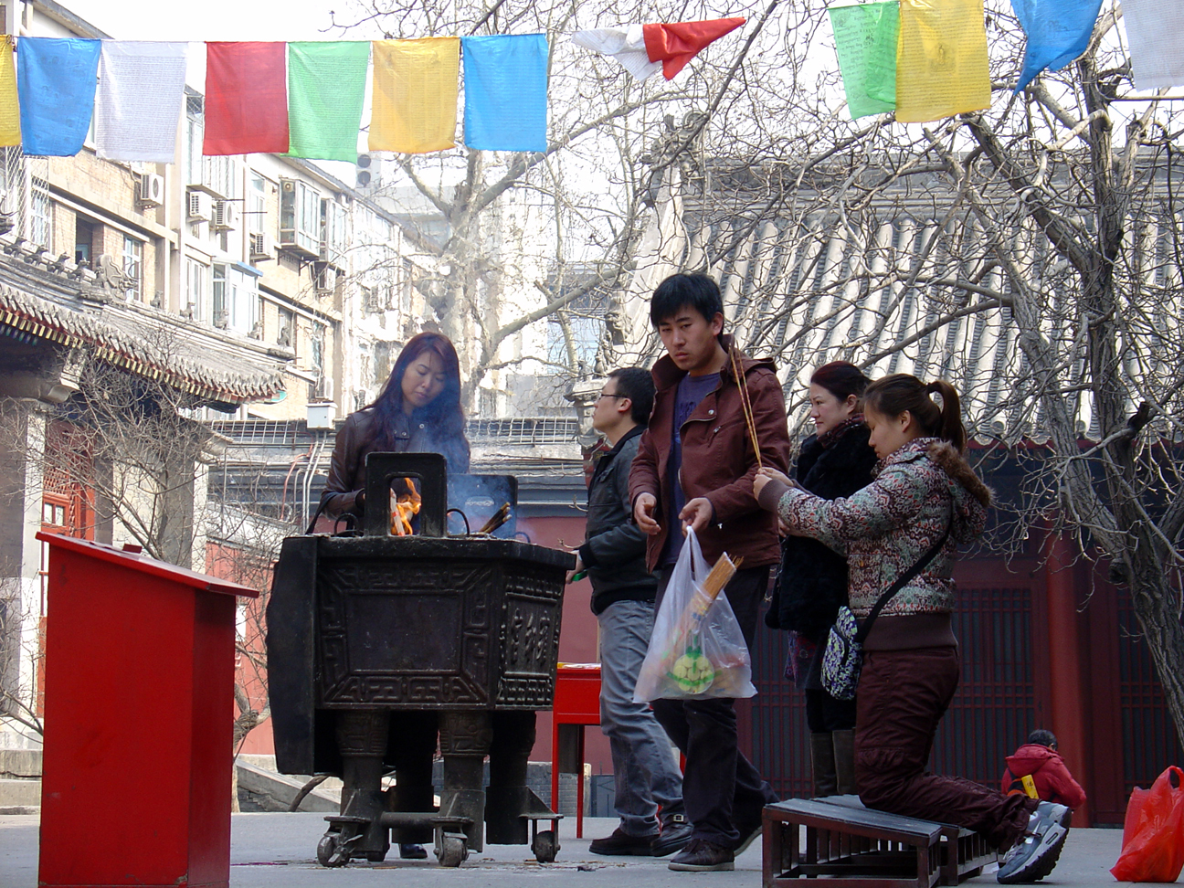 People praying while using incenses