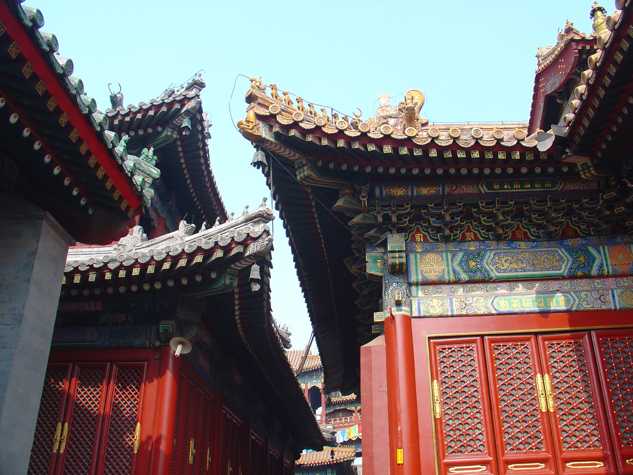 The roofs of two building where a narrow passage leads to the next place