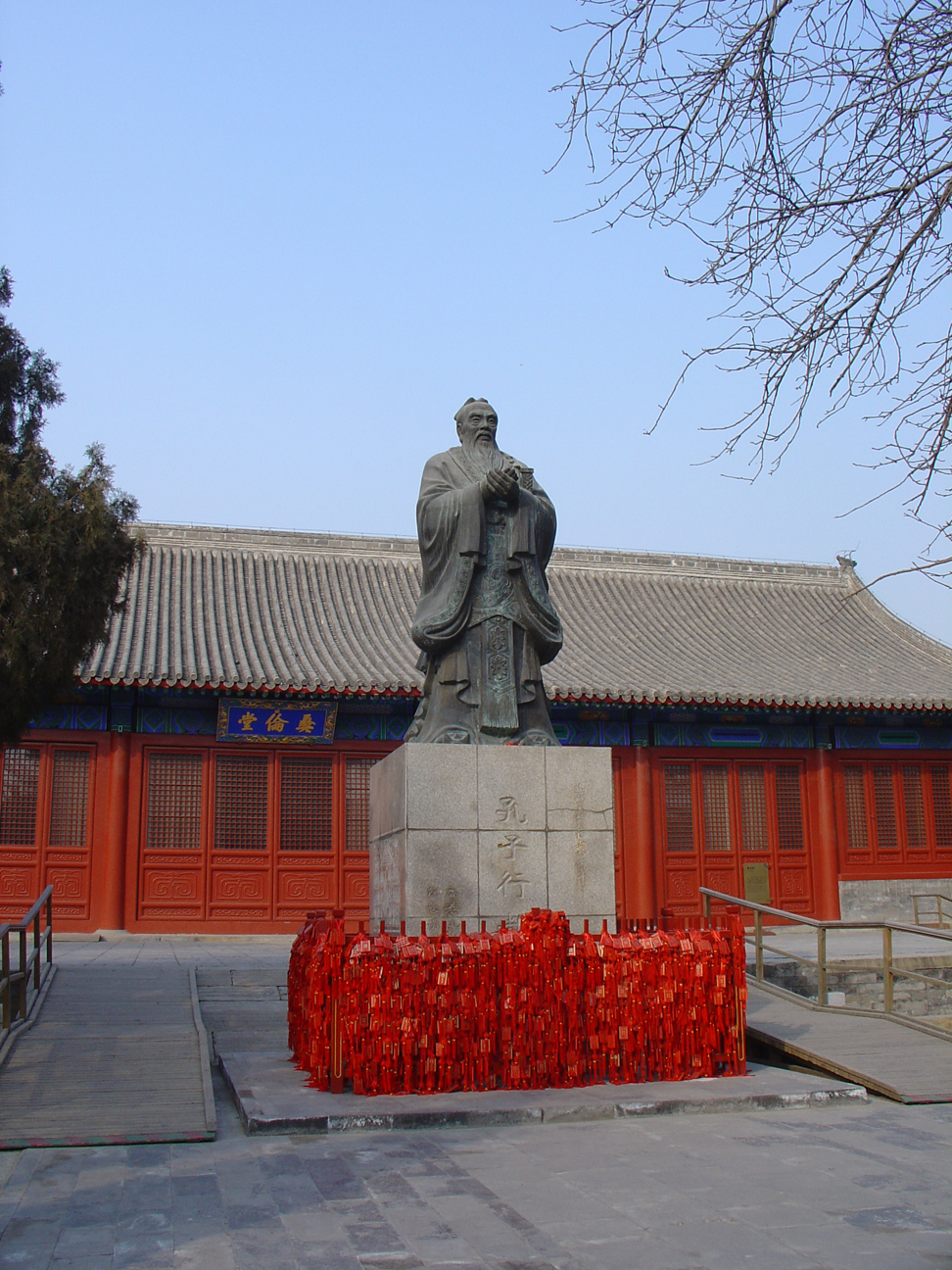 A statue of Confucius surrounded by charms