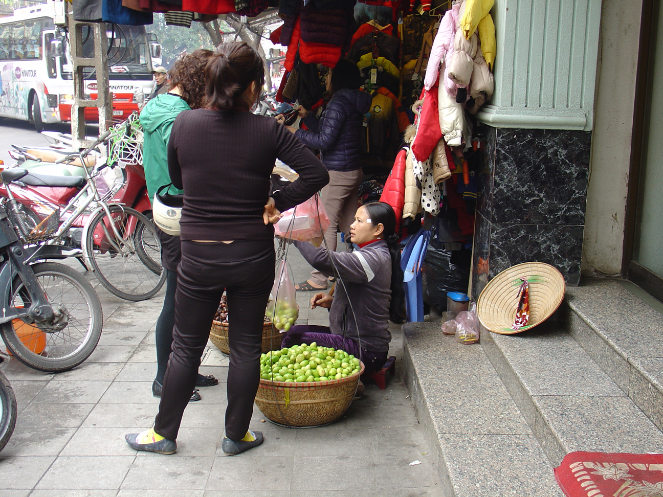 A vendor selling green fruits