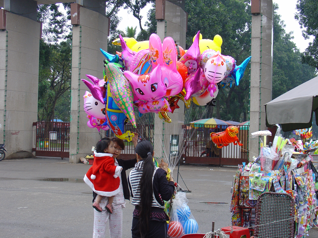 A women buying balloons for a young child