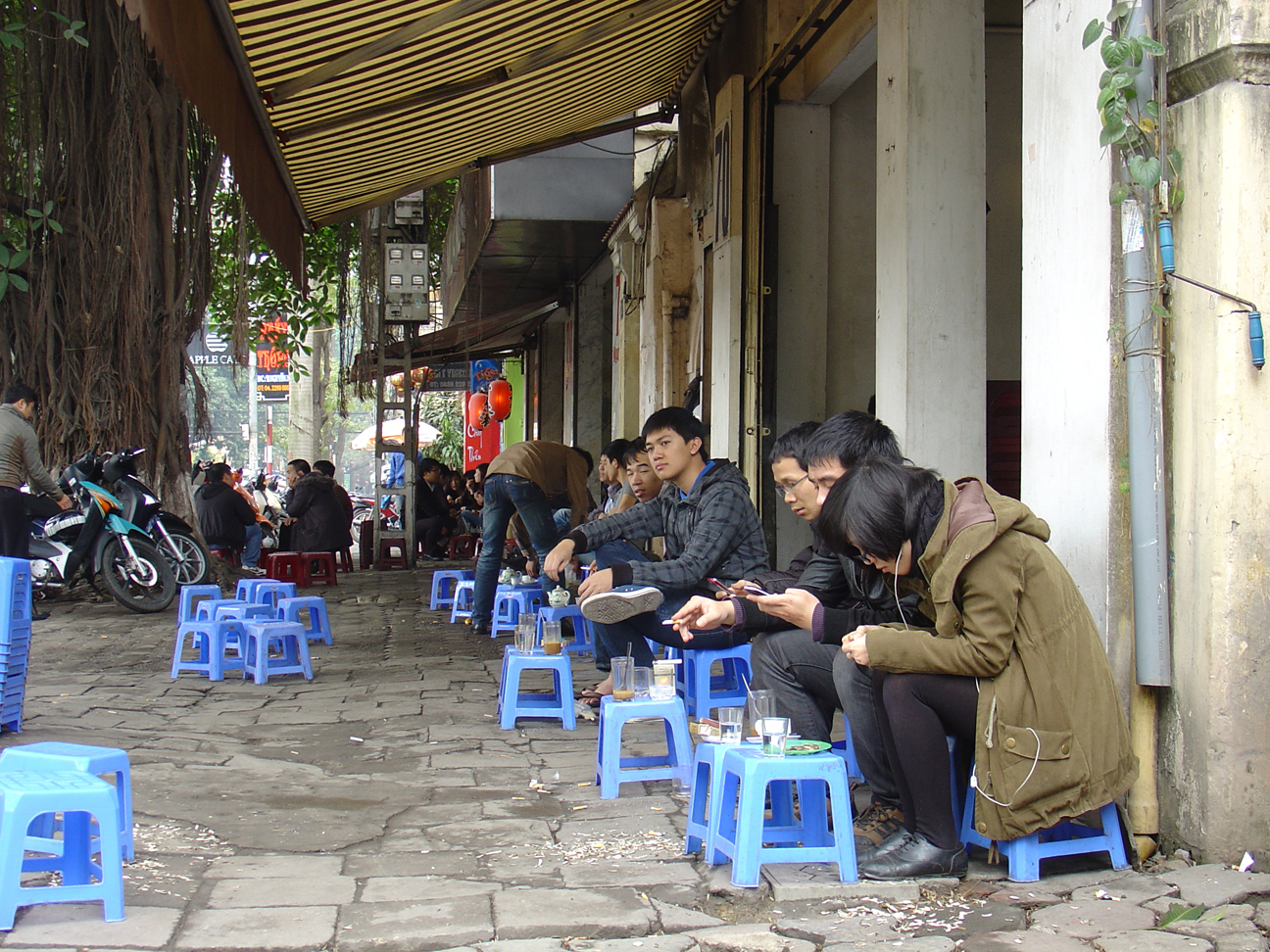 People drinking tea at the street in the morning.