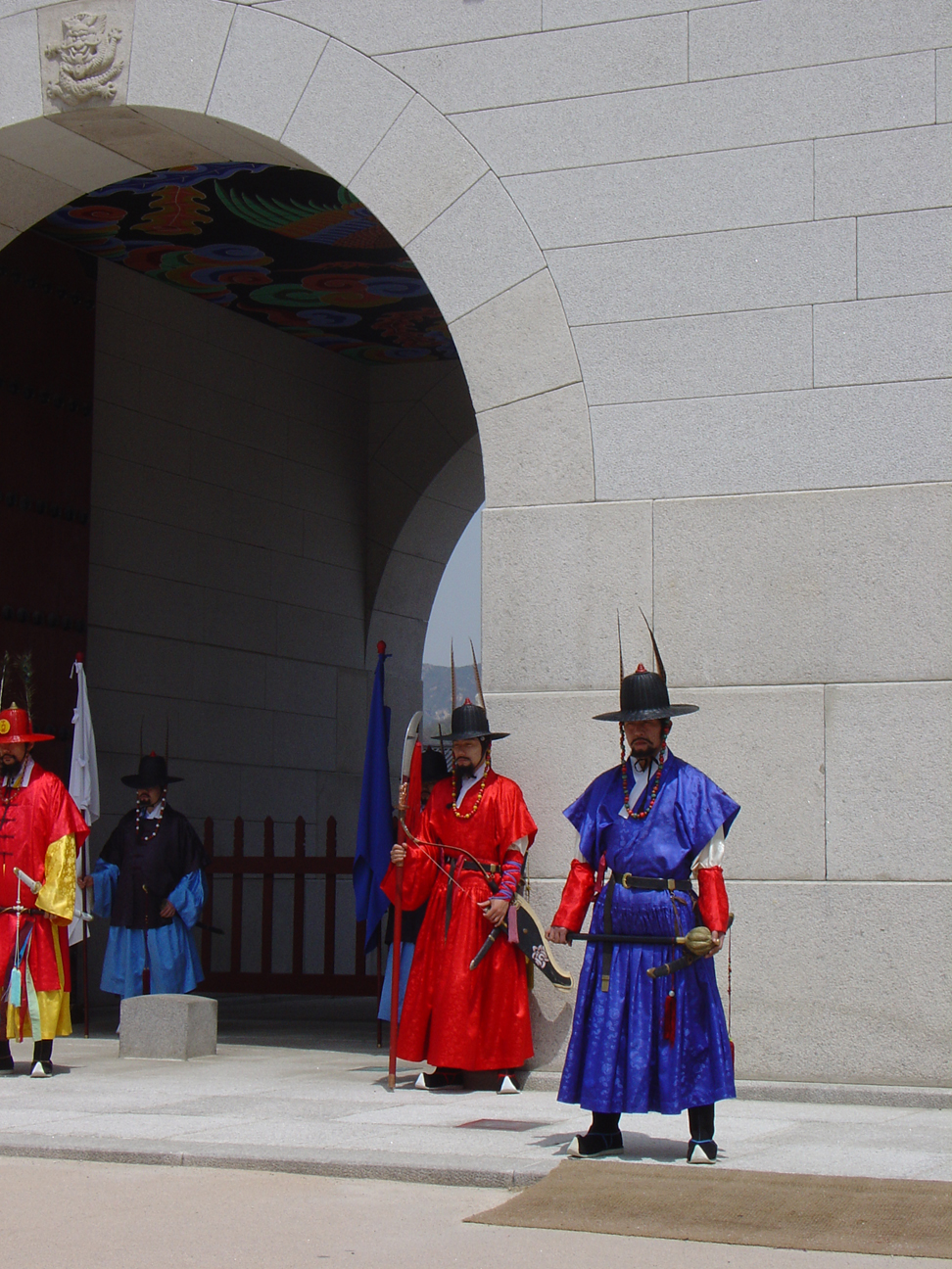 Guards in traditional dresses standing at the front entrance.