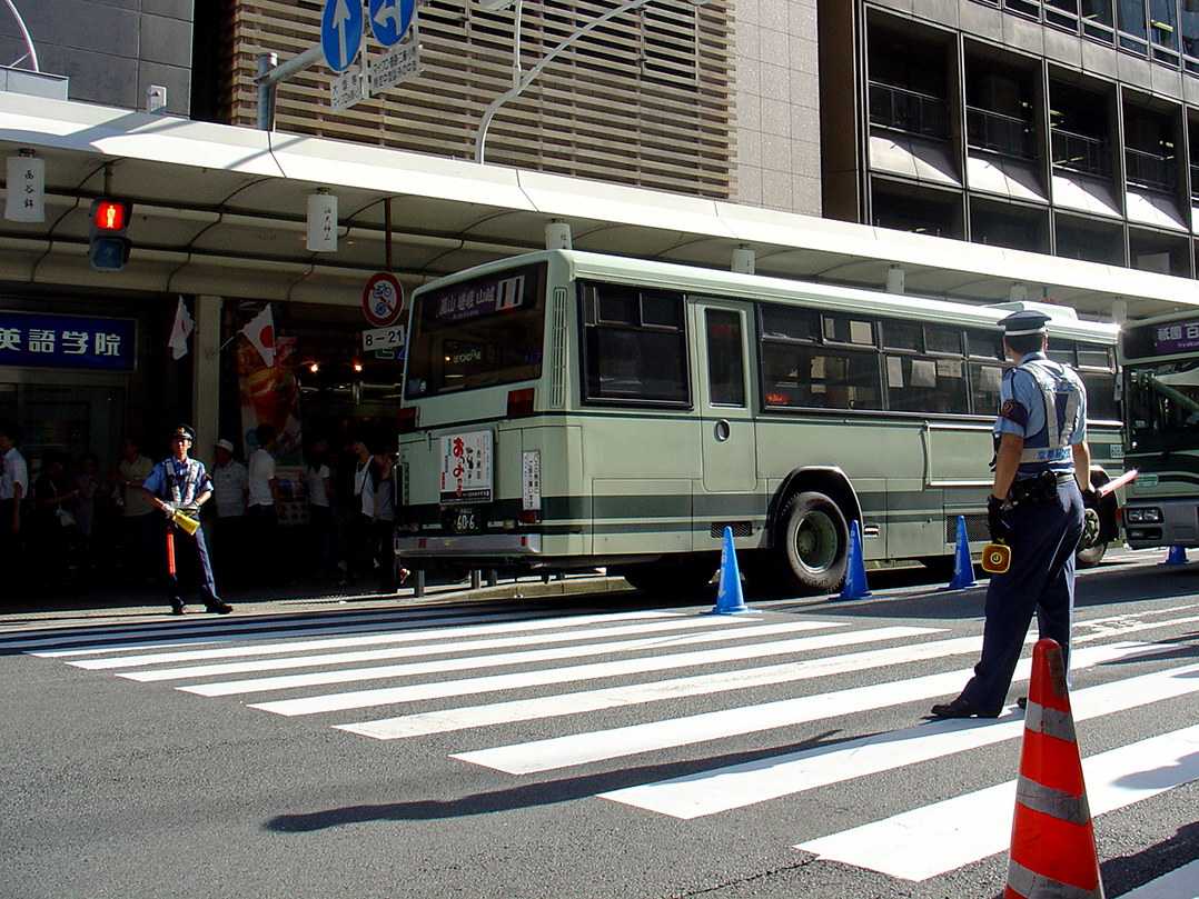 Two policemen guarding a pedestrian crossing.