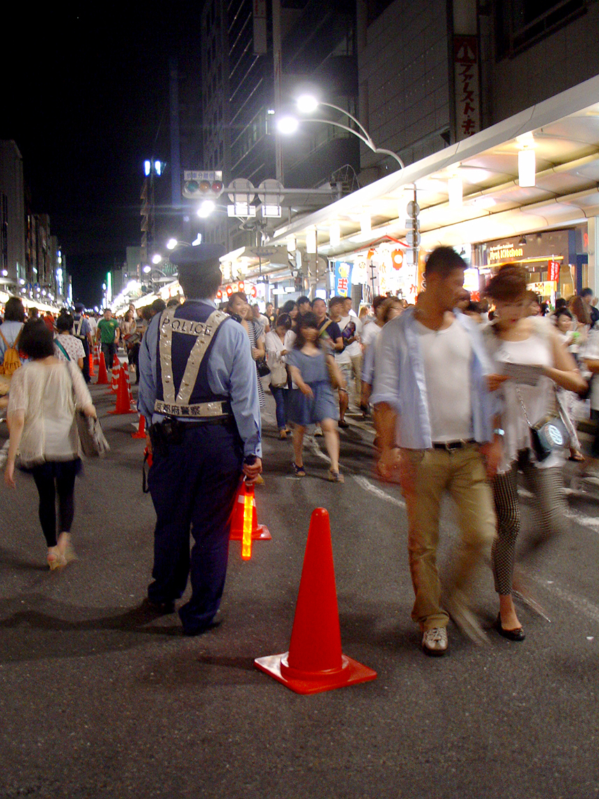 A police man holding a glowing rod.