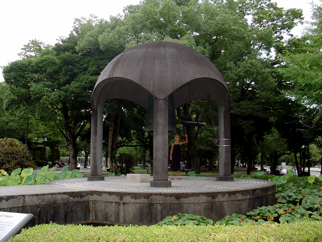 A foreign girl rings the Bell of Peace.